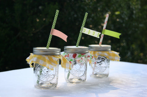 cloth covered mason jars with paper straws and washi tape flags for summer event