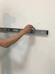 Draw level guide line in preparation for wall padding installation