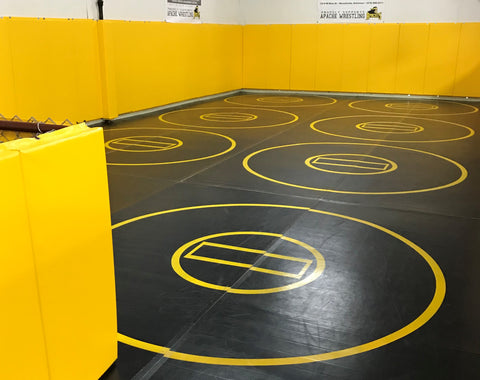 Black practice mat with yellow circles and wall pads
