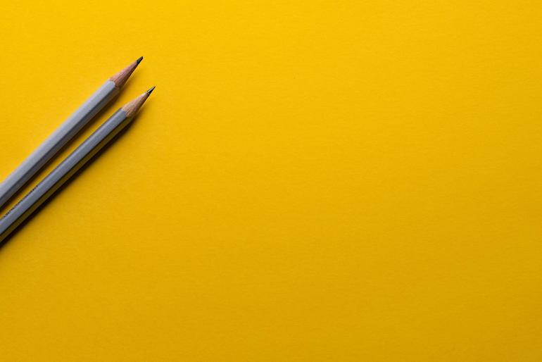 design brief: 2 pencils on a yellow background