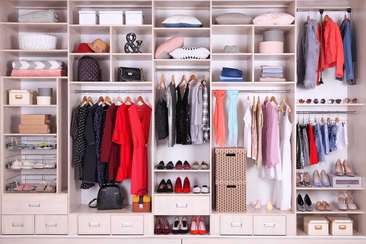 A very organized wardrobe closet with kinds, types, and styles of clothes, shoes and accessories neatly organized in separate compartments.