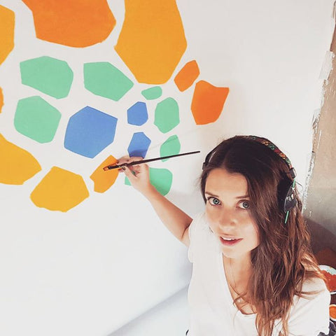 Lourdes Villagomez painting a mural