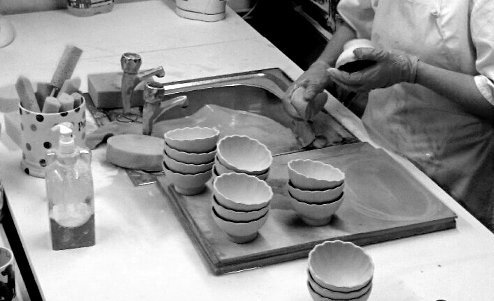 Ceramic items being Fettled and Sponged before firing in the kiln