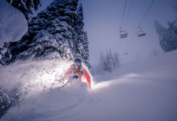 skier at big white slashing pow