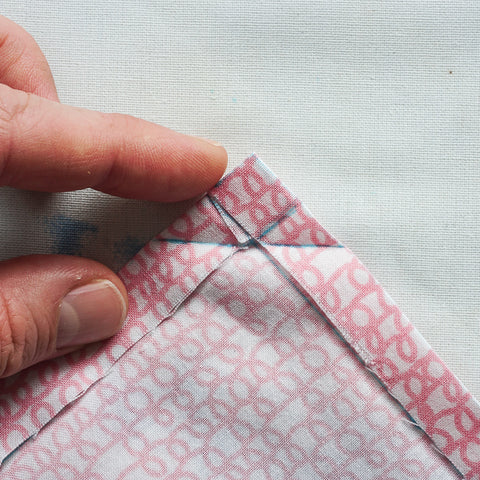 sew a mitered corner on a double fold hem