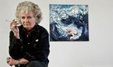 picture of Maggi Hambling smoking with a picture behind her