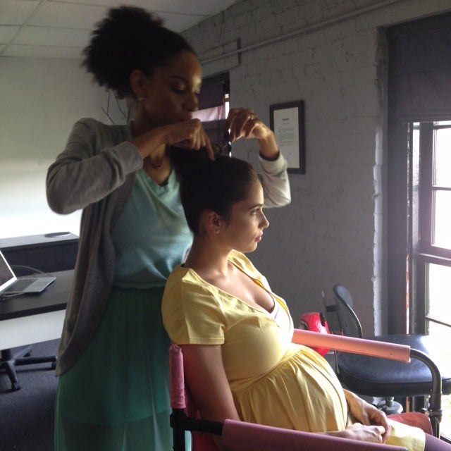 woman with her hair being fixed for Preggo Leggings photoshoot