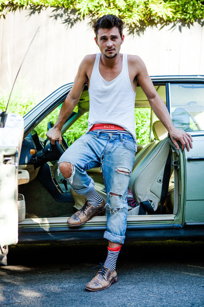 Shiloh Fernandez in Related Garments socks and underwear getting out of a vintage car. 