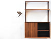 Single bay of rosewood shelving by CADO