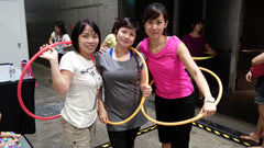 Hula hoop contest together with supportive friends.