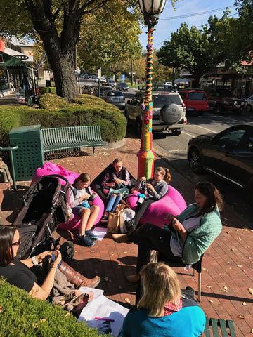 knitting in beanbags on the pavement outside Crumbz Craft