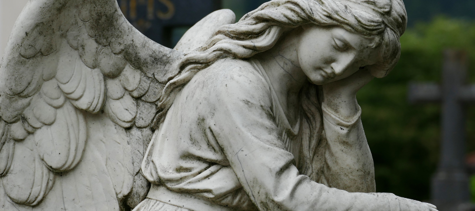 Closeup of angel statue in cemetery