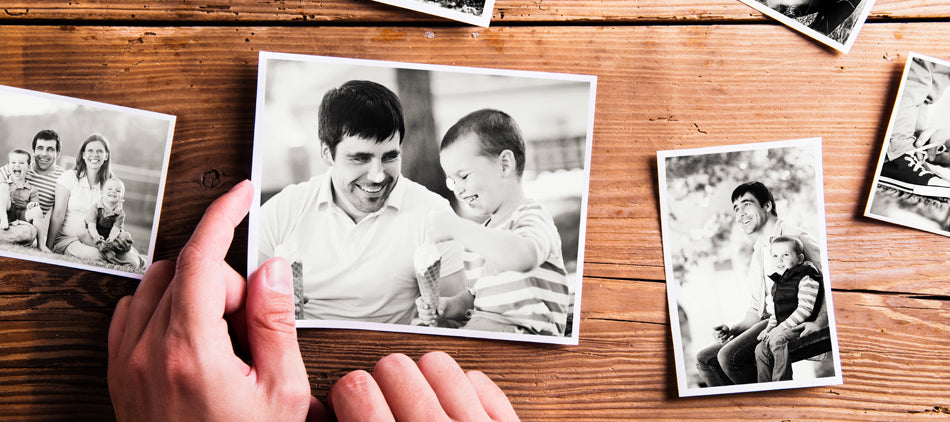 Hands Holding a Photo as Part of Photo Display