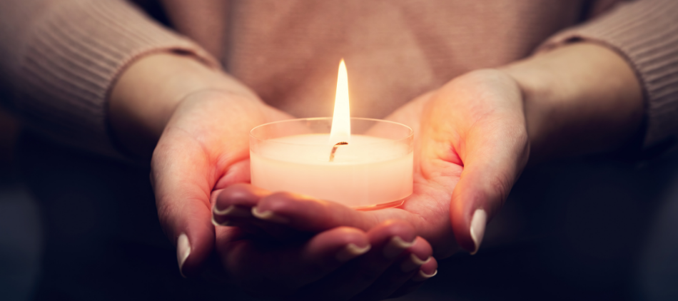 Hands Holding Lit Candle