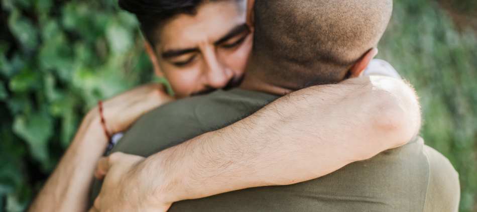 Two men hugging and comforting each other