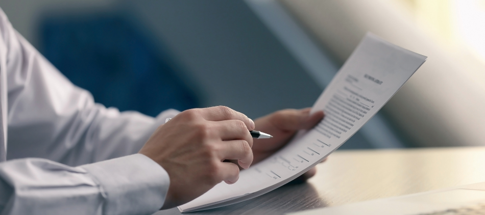 Closeup of person&#039;s hands holding contract and pen