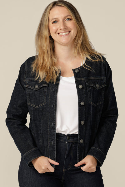 A collarless, ethical denim jacket in size 12 is worn with white bamboo jersey T-shirt and super-stretch skinny jeans. Ethically and sustainably made in partnership with Outland Denim, this comfort stretch denim jacket is tailored to fit women in sizes 8 to 24 by Australian and New Zealand women's clothing label, L&F.