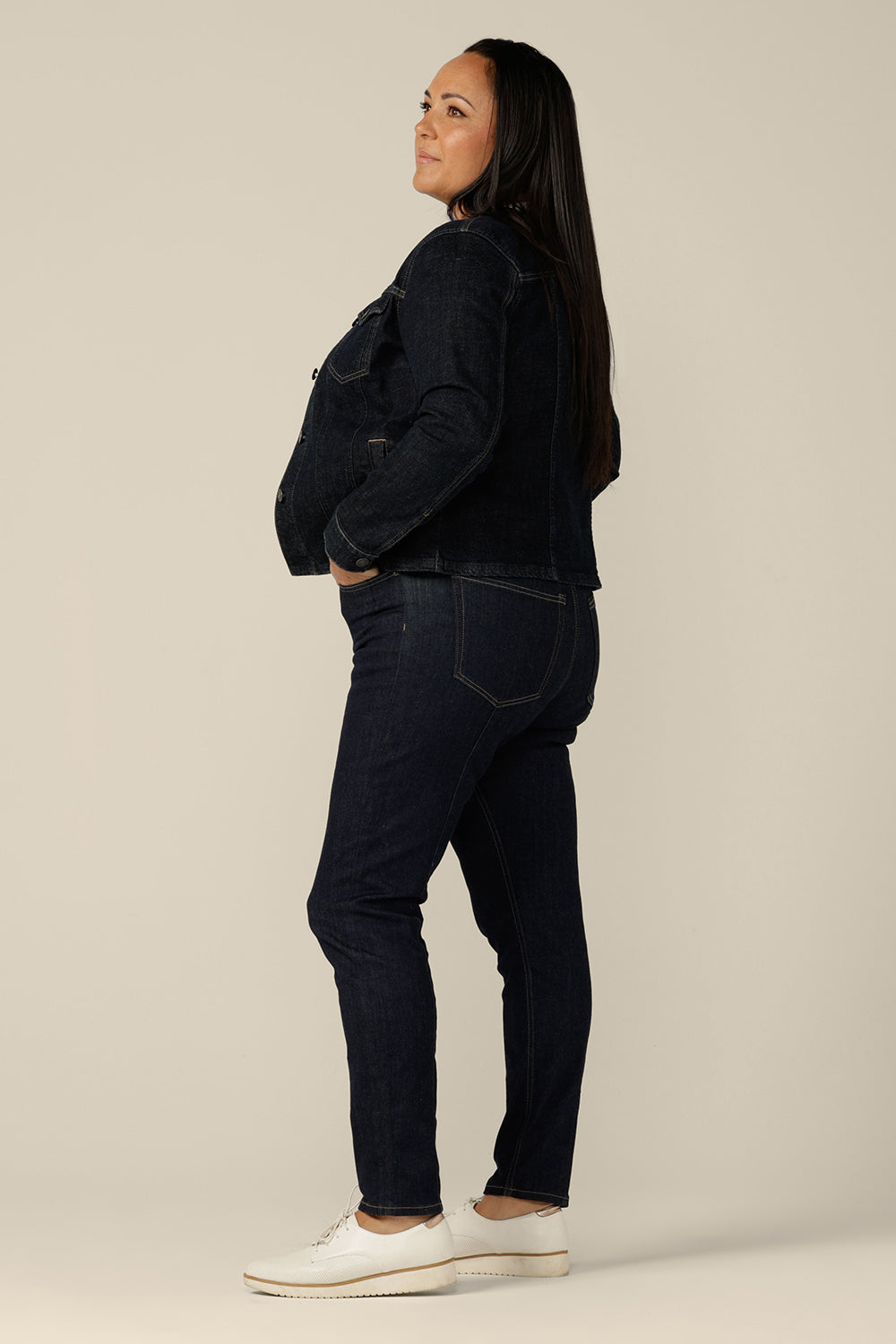 A collarless denim jacket in size 18 is worn with white bamboo jersey T-shirt and super-stretch skinny jeans. Ethically made from organic cotton, this denim jacket is tailored to fit women in sizes 8 to 24 by Australian and New Zealand women's clothing experts, L&F.