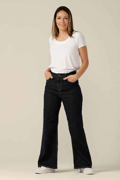 High-waisted, flared leg jeans in midnight denim, size 8, worn with a white bamboo jersey top. Ethically and sustainably made by Australian and New Zealand women's clothing brand, L&F.