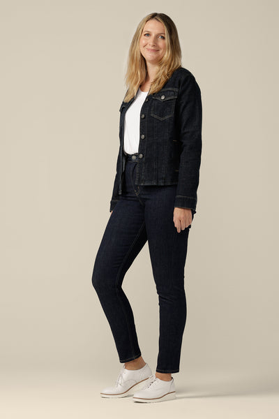 A collarless, conscious denim jacket in size 12 is worn with white bamboo jersey T-shirt and super-stretch skinny jeans. Ethically and sustainably made in partnership with Outland Denim, this denim jacket is tailored to fit women in sizes 8 to 24 by Australian and New Zealand women's clothing brand, L&F.