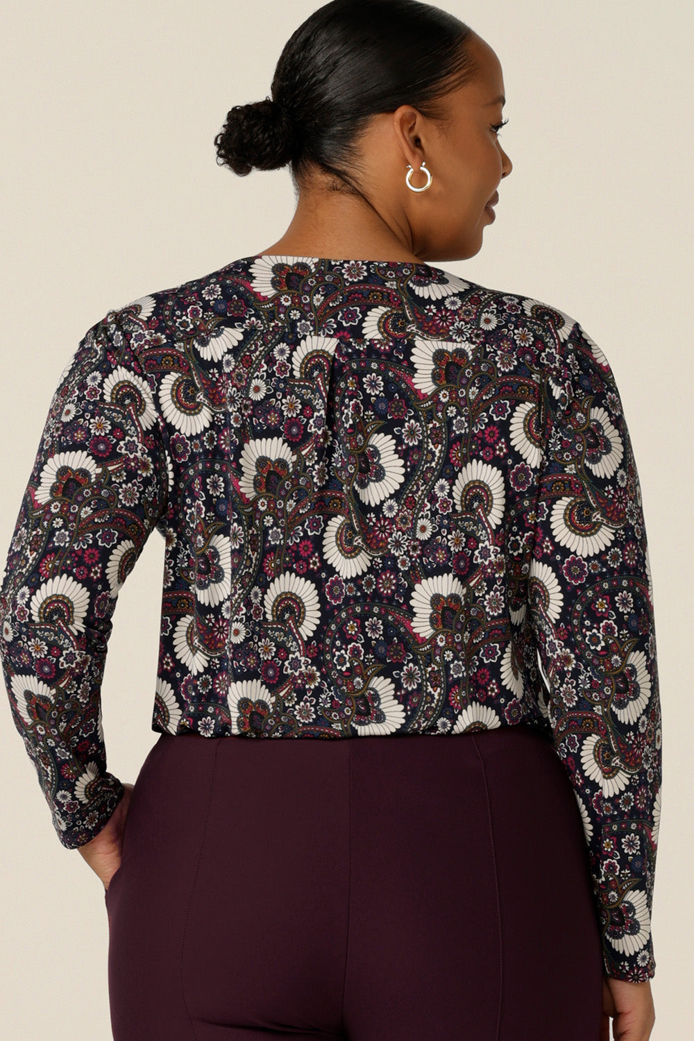 Back view of a  fuller figure woman wearing a long sleeve, cowl neck top in paisley print jersey, size 18. A good top for work, the Chrissy Top is made in Australia by Australian and New Zealand women's fashion brand, L&F. Shop work tops now in sizes 8 to 24