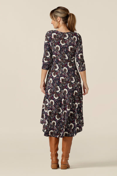 Back view of a 3/4 sleeve empire line dress with twist front bodice ad dipped, calf length hem in a size 10. Made in Australia by Australian and New Zealand women's clothing label, L&F this paisley print jersey dress is great for work and weekend wear. 