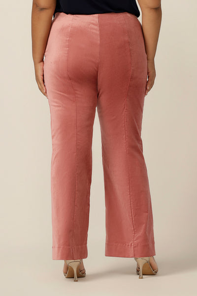 Back view of flared leg, tailored pants in musk pink velveteen. Made in Australia by Australian and New Zealand women's clothing brand, L&F, these special event pants are are available to shop in an inclusive size range of sizes 8 to 24, petite to plus sizes.