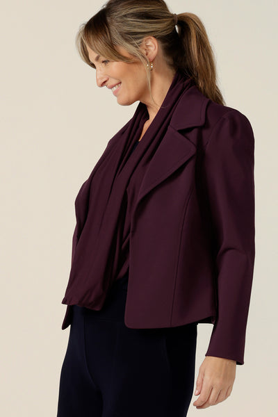 Model wears the Garcia Jacket in Mulberry ponte fabric by Australian and New Zealand women's clothing brand, L&F. Featuring collar and notch lapels and long sleeves, this open-fronted jacket is good for corporate wear and casual wear.