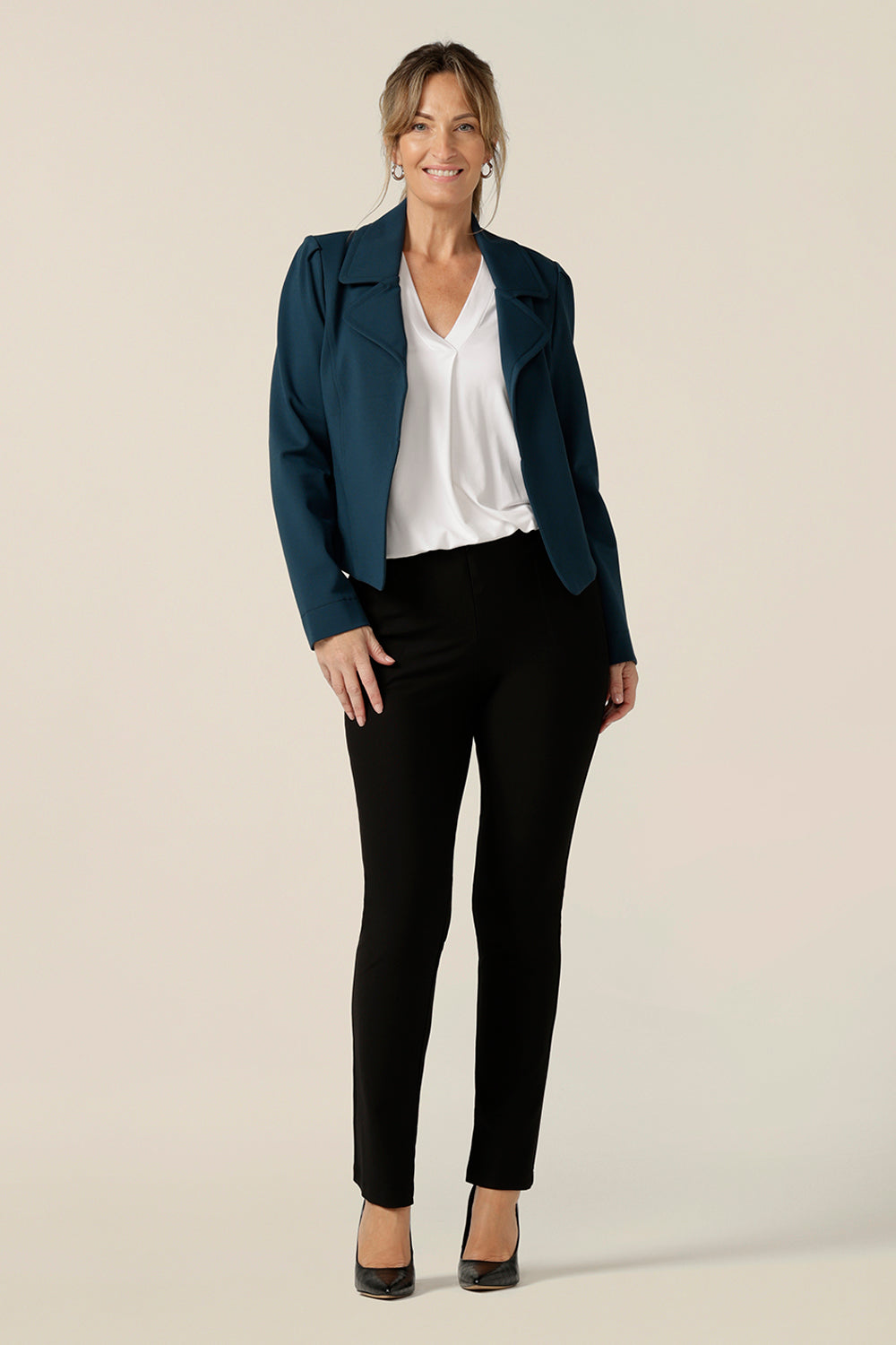 Model wears the Garcia Jacket in Petrol ponte fabric by Australian and New Zealand women's clothing brand, L&F. Featuring collar and notch lapels and long sleeves, this open-fronted jacket is good for corporate wear and casual wear.