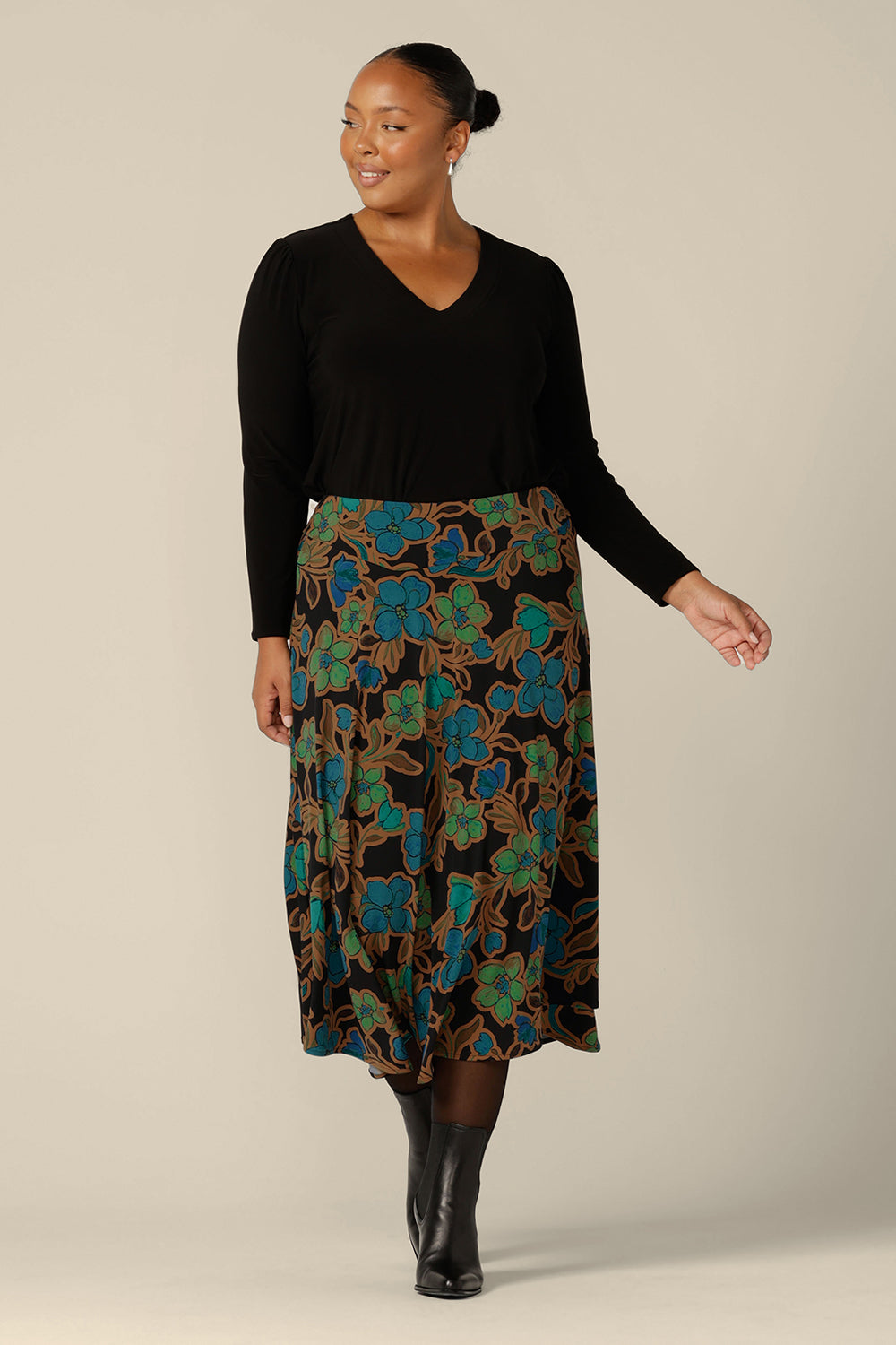 An asymmetric, midi skirt by Australian and New Zealand women's clothing brand, L&F. The Germaine Skirt in floral 'Secret Garden' print jersey is worn with a long sleeve, V-neck top in black jersey.  A good skirt for the modern woman, shop this jersey skirt in sizes 8 to 24.