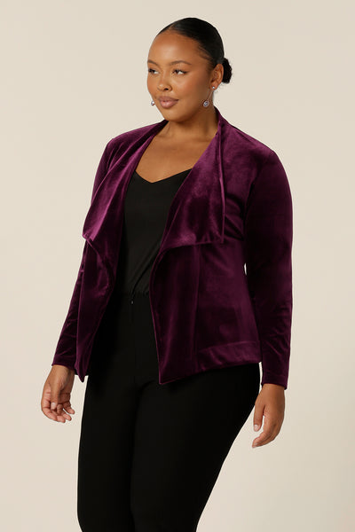 Occasionwear dressing at its finest, this soft tailoring jacket in red wine velour adds effortless glamour to black cocktail wear. Shown here over a black cami top and slim leg black trousers, this open front, soft collared evening jacket is made in Australia in sizes 8 to 24.