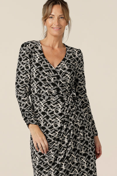 A great work dress, this is a long sleeve wrap dress with tulip skirt in black and white print  jersey is by Australian and New Zealand women's clothing label, L&F. Worn by a fuller figure woman, this jersey wrap dress is available in inclusive sizes, 8 to 24.