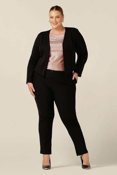 A sophisticated evening and occasionwear suit look, the shimmering Jody Top  in pink Xanadu jersey is worn with slim leg black pants and a tailored black jacket. A scoop neck top with long sleeves, this evening top wears well for events, wedding and cocktail parties. 
