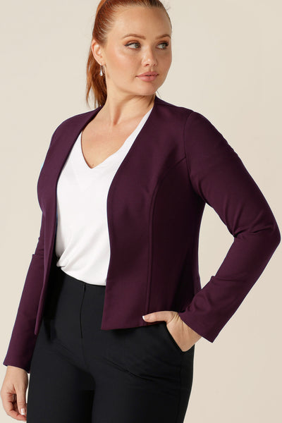 A good workwear jacket, the Mackenzie Jacket in Mulberry by Australian and New Zealand womenswear brand, L&F is a collarless, open front jacket with long sleeves and an angled hem. Made in Australia and shown in a size 12, shop this corporate wear jacket in an inclusive size range of 8 to 24. 