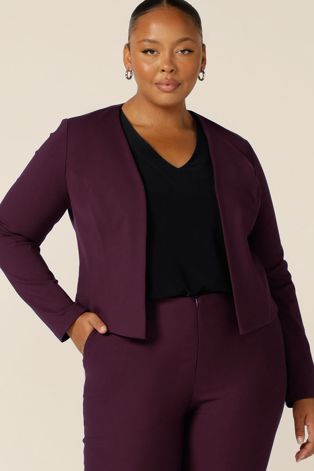A good workwear jacket for plus size women, the Mackenzie Jacket in Mulberry is available to shop in sizes 8 to 24. Made in Australia by Australian and New Zealand womenswear brand, L&F, this work jacket is a collarless, open fronted with long sleeves and an angled hem. 