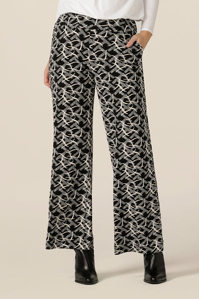 A size 10 woman wears wide leg, pull pants with a deep waistband in black and white jersey. Made in Australia by Australian and New Zealand women's clothing brand, L&F these easy care pants are great for work and corporate wear.