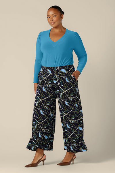 Australian-made wide-leg pants in a size 18 by Australian and New Zealand women's clothing label, L&F. Featuring a blue, green and white abstract print on navy-base jersey, these stretch-fit wide leg trousers wear well for workwear or casual wear. Worn with an opal blue jersey top, shop these cropped length pants in petite to plus sizes.