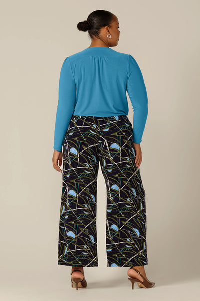 Back view of Australian-made, wide-leg pants by Australian and New Zealand women's clothing brand, L&F. Featuring a blue, green and white abstract print on navy-base jersey, these stretch-fit wide leg trousers wear well for workwear or casual wear.