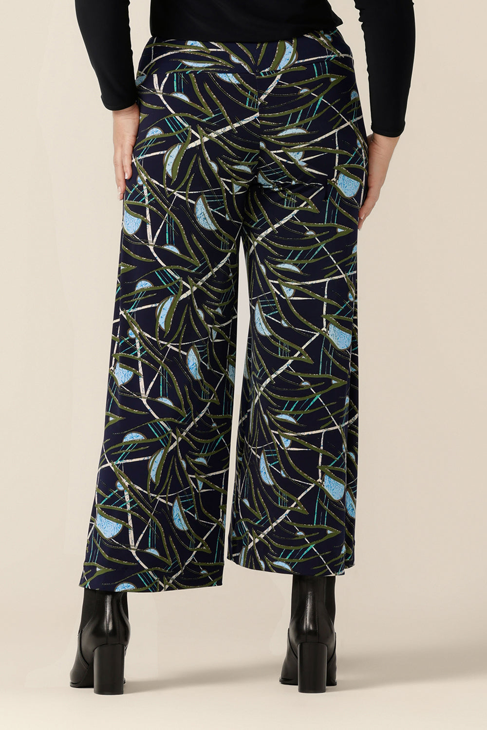 Back view of Australian-made, wide-leg pants by Australian and New Zealand women's clothing label, L&F. Featuring a blue, green and white abstract print on navy-base jersey, these stretch-fit wide leg trousers wear well for workwear or casual wear.