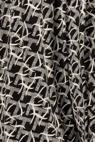 a swatch of the graphic black and white Thornbirds print on dry touch jersey, used by Australian and New Zealand women's clothing label, L&F to make a range of workwear tops, dresses and pants for women.