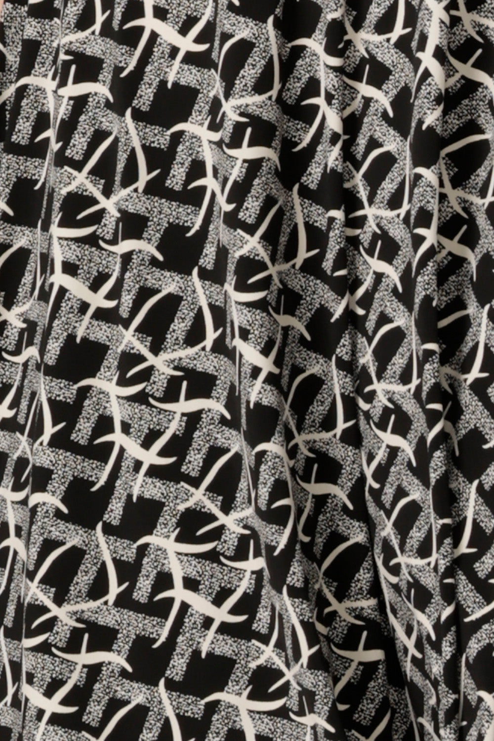 a swatch of the graphic black and white Thornbirds print on dry touch jersey, used by Australian and New Zealand women's fashion label, L&F to make a range of workwear tops and dresses for women.
