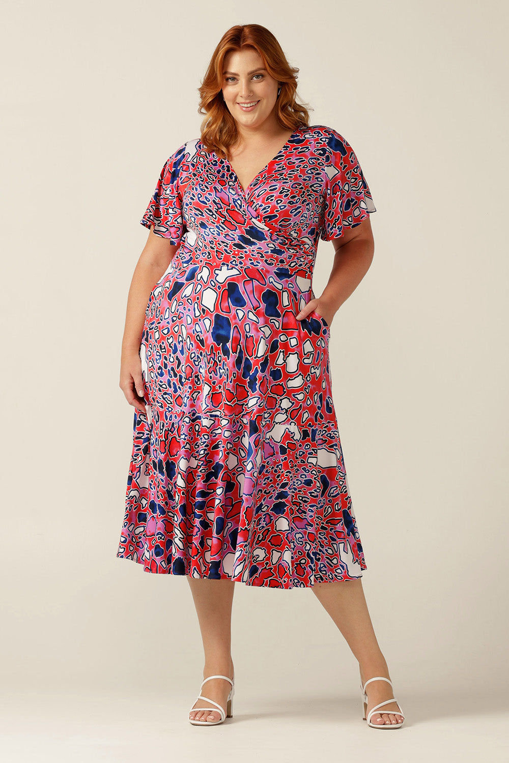 fixed wrap jersey dress with flutter sleeves, pockets and ruffle on skirt.