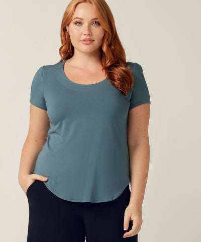 The Sawyer Top in Black Bamboo is a Beautifully Tailored Top with a Curved Shirttail Memline and Short Sleeves. The front has a round neckline with topstitch detail and bust darts for shaping. Available in size 8-24 and Proudly Made in Australia.