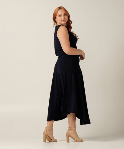 Sleeveless dress with cowl-neckline and asymmetrical skirt.