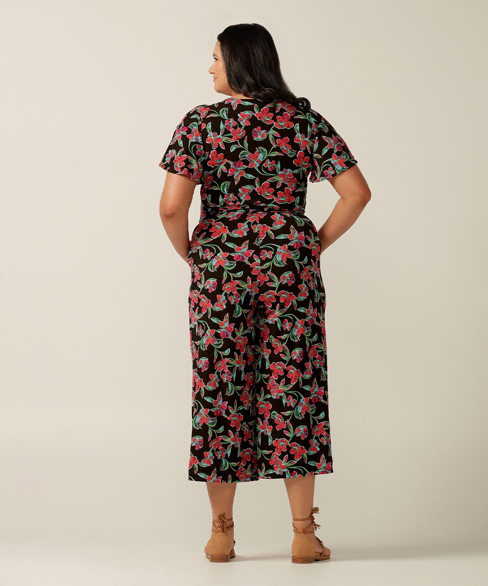 Wrap-front stretch jersey jumpsuit with short flutter sleeves and wide cropped legs. Featuring an exclusive colourful floral print, this jumpsuit is made in Australia for plus size women, petite women and women looking to build a capsule wardrobe.