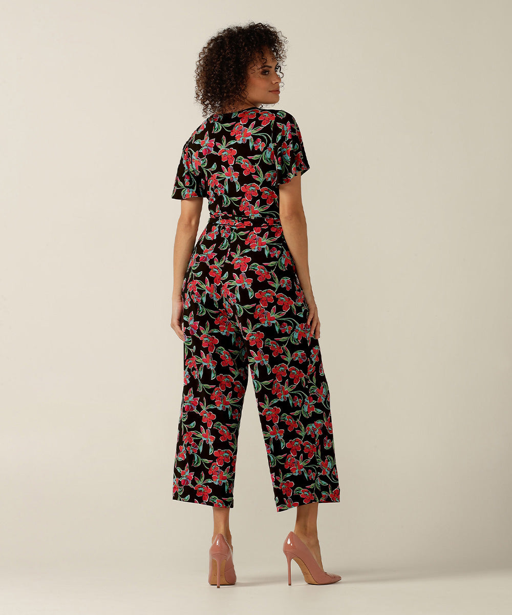 Wrap-front stretch jersey jumpsuit with short flutter sleeves and wide cropped legs. Featuring an exclusive colourful floral print, this jumpsuit is made in Australia for plus size women, petite women and women looking to build a capsule wardrobe.