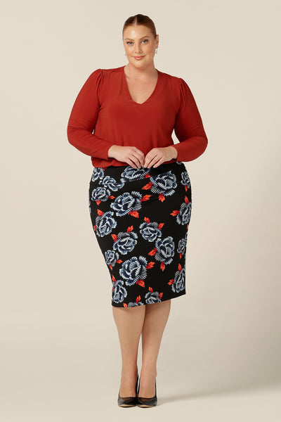 Tops for petite to plus size women, Australian and New Zealand women's clothing label, L&F's great range of women's tops includes this V-neck jersey top with long sleeves. In orange dry-touch jersey, this coloured top is worn with a blue and orange floral print on a black jersey tube skirt. 