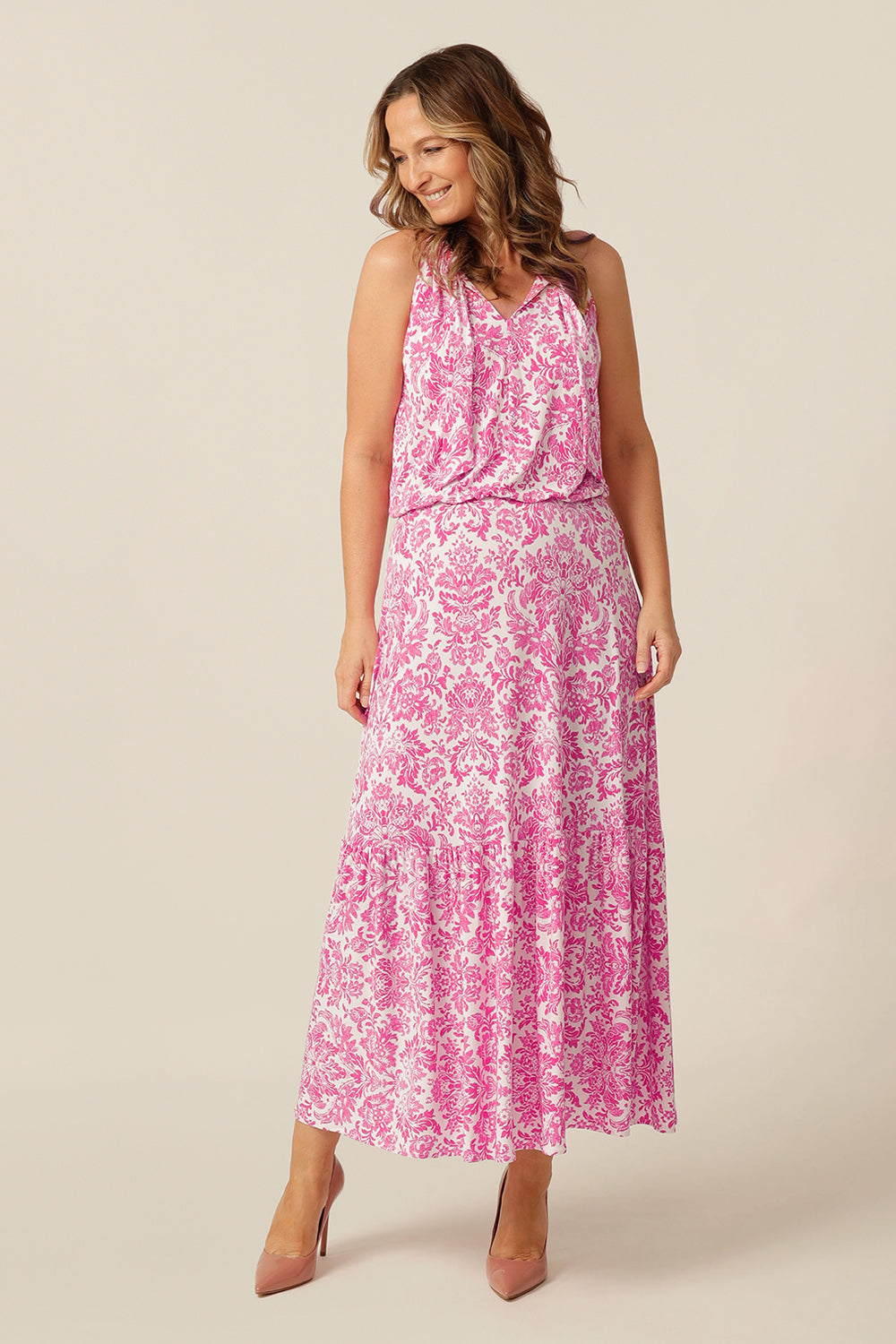 model wears white and pink patterned maxi dress australia