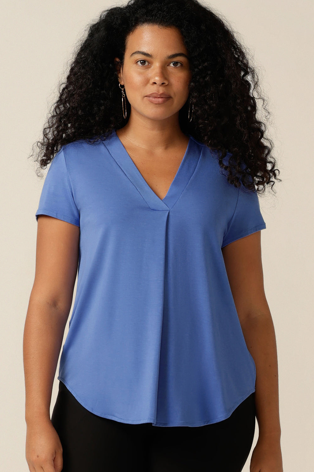 A curvy size 12 woman wears a short-sleeved V-neck top in bamboo jersey. Lightweight, breathable and made from natural fibres, bamboo jersey makes for a comfortable and cool jersey top. Made from sustainable fibres and Australian-made, this women's bamboo jersey top highlights 2 way L&F clothing is working towards producing more eco-conscious, sustainable fashion