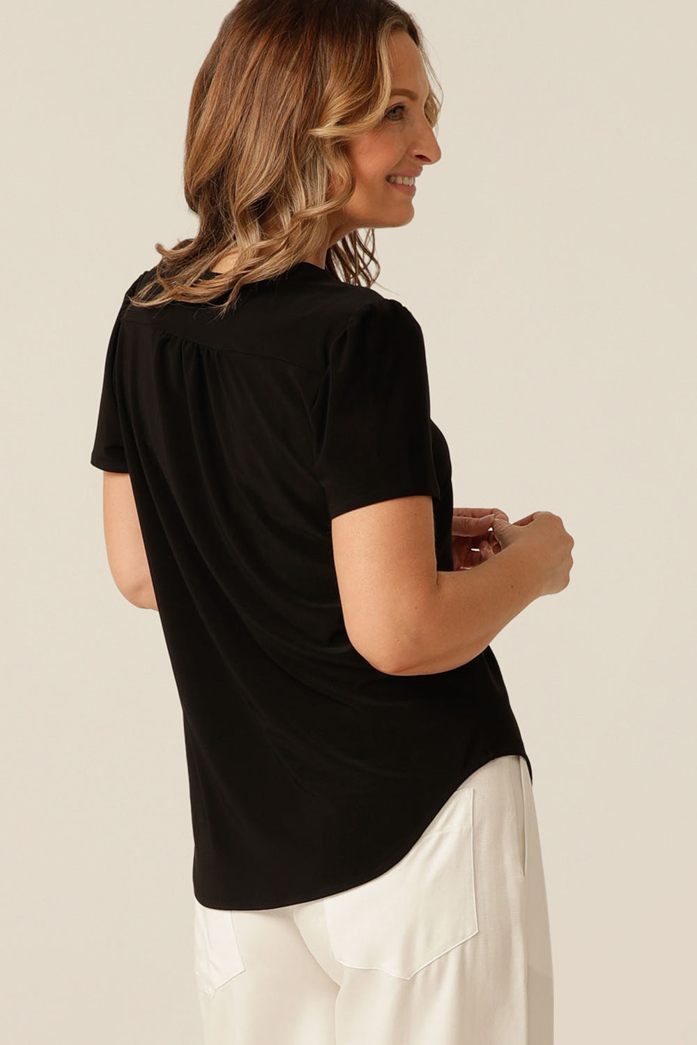 tailored short sleeve top with v-neckline and shirttail hemline